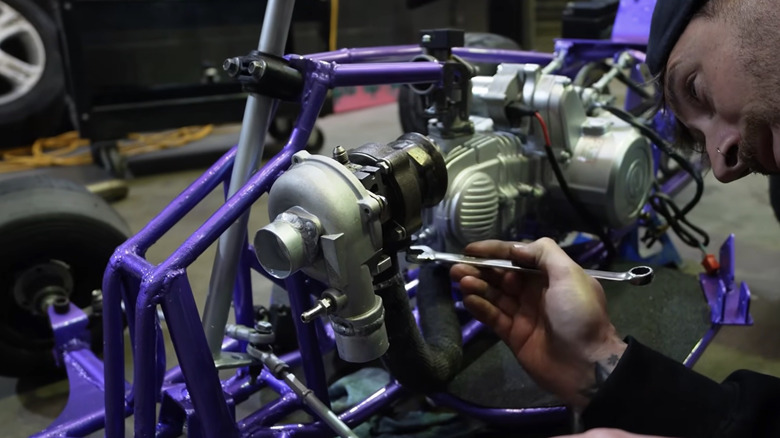 YouTuber Mike Lake mounting up a tiny turbocharger to his 150cc go-kart build.