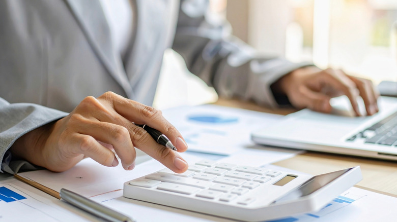 A person using a calculator