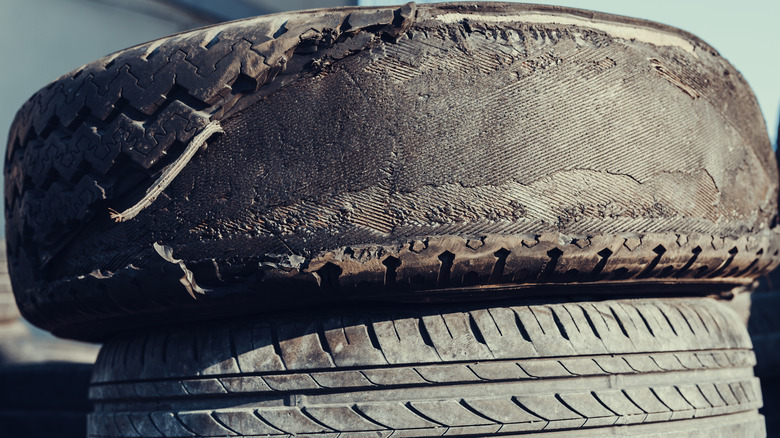 Worn out car tire stacked on another tire
