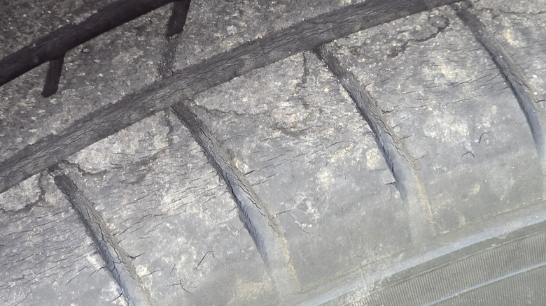 Old tire with hairline cracks on the tread blocks