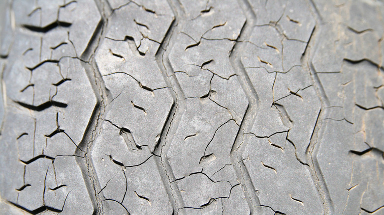 Old tire with dry rot and visible cracks on the tread surface