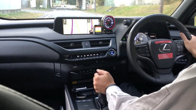 Interior view of driving an electric Lexus UX 300e with a simulated manual transmission
