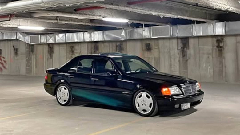 A black Mercedes sedan in a parking garage
