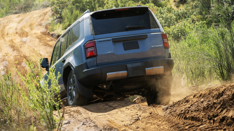 A blue Toyota Land Cruiser off-roading