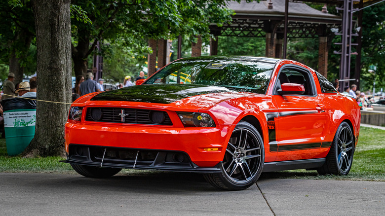 A red 2012 Mustang Boss 302 at a car show.