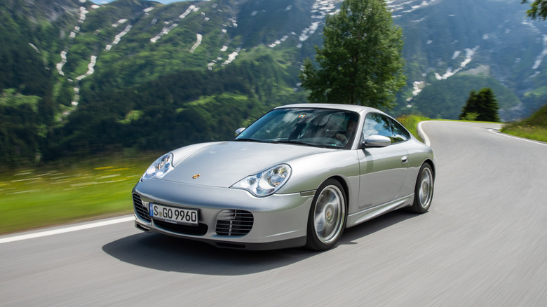 Image of a 996.2 911 Carrera moving down a mountain road.