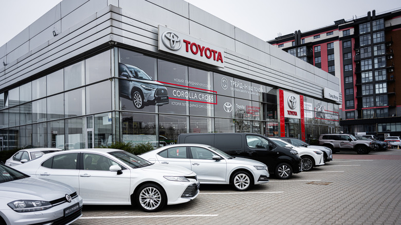Khmelnytskyi, Ukraine - April 16, 2025: Toyota dealership facade with multiple cars parked in front, highlighting urban architecture  by: AS project
