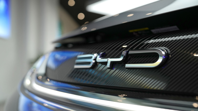PENANG, MALAYSIA - 20 OCT 2023: Car logo of a BYD Build Your Dreams EV car. BYD Co. Ltd. is a publicly listed Chinese conglomerate manufacturing company headquartered in Shenzhen, Guangdong, China.
