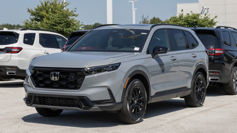 Avon - August 3, 2025: Honda CR-V Hybrid AWD Sport L compact SUV display at a dealership. Honda offers the CRV with a 2.0L Hybrid engine. MY:2026