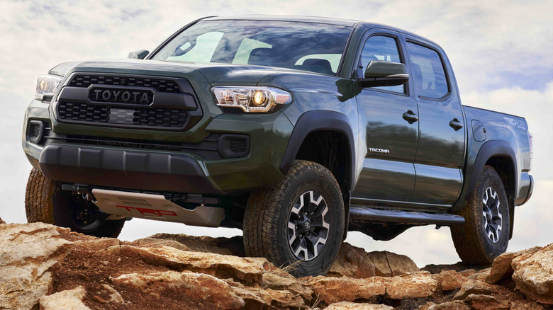 A 2021 Toyota Tacoma parked on a rocky outcrop