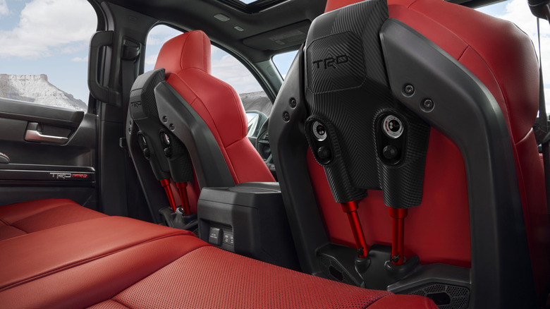 The interior of a 2026 Toyota Tacoma TRD Pro as seen from the rear seats, highlighting the car's specialized IsoDynamic Performance Seats.