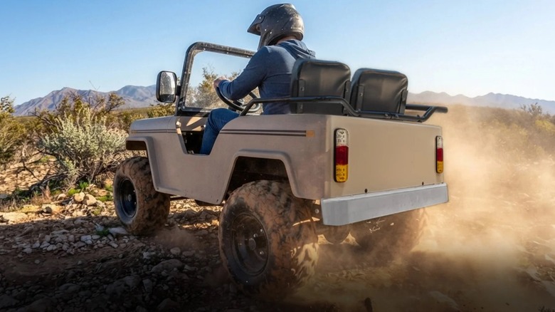 A cream-colored Massimo Mini Truck kicking up dirt in the desert.