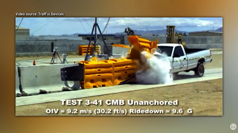 A screenshot showing a white OBS Chevy crashing into yellow water-filled crash cushions in a staged test