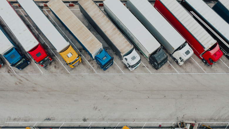 Aerial shot of semi trucks parked at a truck stop.