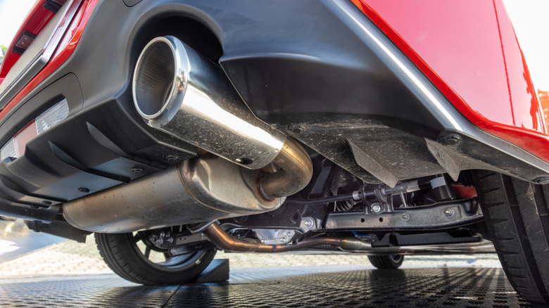 Close-up view of a muffler installed underneath a car