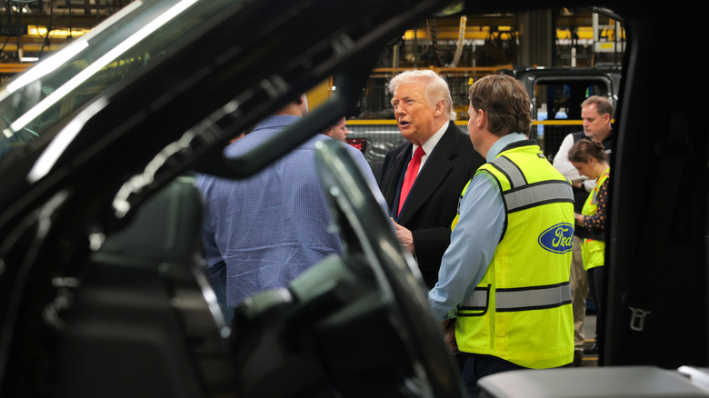 U.S. President Donald Trump (2R) tours the assembly line at the Ford River Rouge Complex on January 13, 2026 in Dearborn, Michigan.
