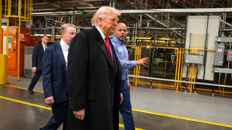 U.S. President Donald Trump (2R) walks with Ford River Rouge Plant Manager Corey Williams (R), and Executive chair of Ford Motor Company Bill Ford Jr. (RL) as they tour the Ford River Rouge Complex on January 13, 2026 in Dearborn, Michigan.