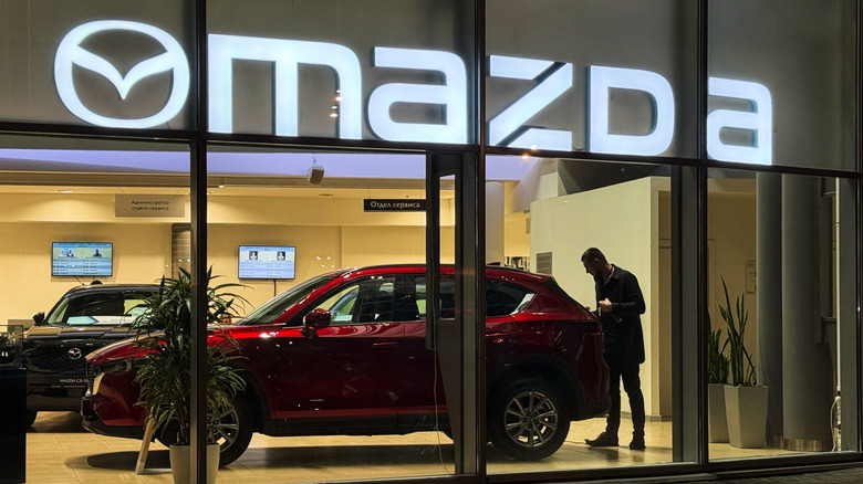 St-Petersburg, Russia, November 5, 2025: Exterior view of Mazda dealership at night LED backlight. Dealer store Mazda. Brand's showroom. Mazda Motor Corporation is a Japanese multinational automaker.
