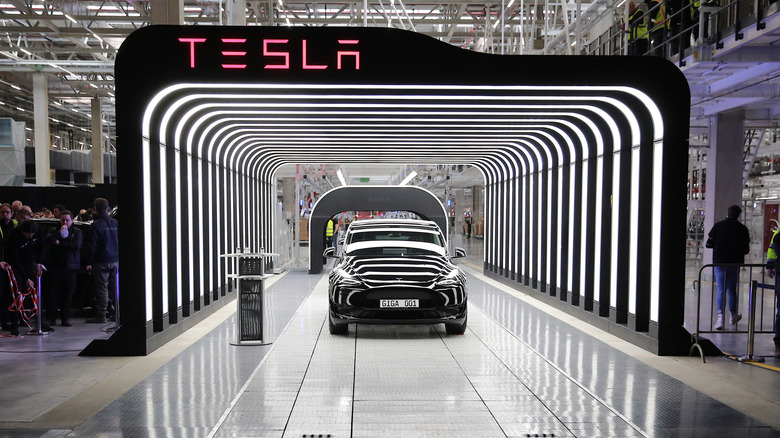 A completed tesla car emerges from the German plant