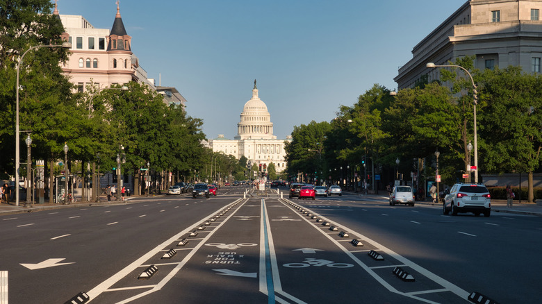 United States Capitol Building from the Street - The U.S. Capitol Building seen from a wide street with bike lanes and trees on a sunny day in Washington, D.C.