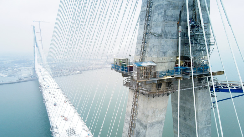 the gordie howe bridge under construction on a snowy day.
