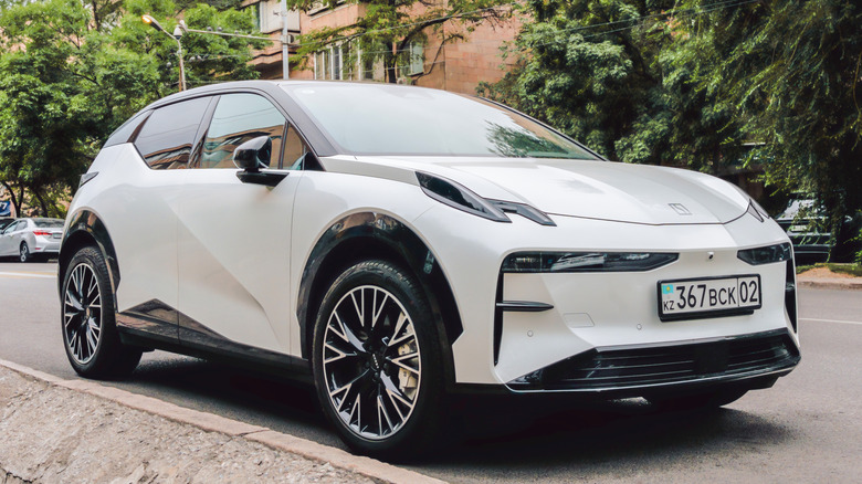 A white Zeekr parked along the side of the road.