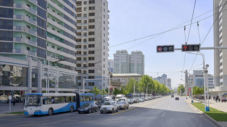 Cars and a bus stopped at a red light on one of the highways of Pyongyang