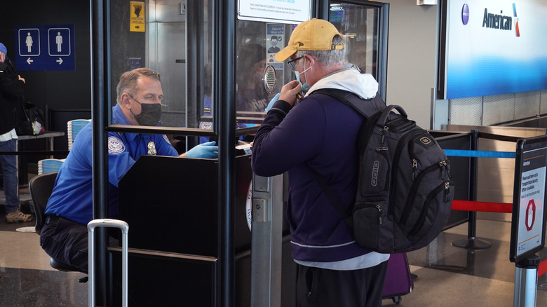 CHICAGO, ILLINOIS - NOVEMBER 08: Transportation Security Administration (TSA) workers screen passengers at O'Hare International Airport on November 08, 2021 in Chicago, Illinois. Monday is the deadline for federal workers to report whether they have been vaccinated against the COVID-19 coronavirus. Recent data indicate that only about 60 percent of TSA workers have reported being vaccinated. (Photo by Scott Olson/Getty Images)
