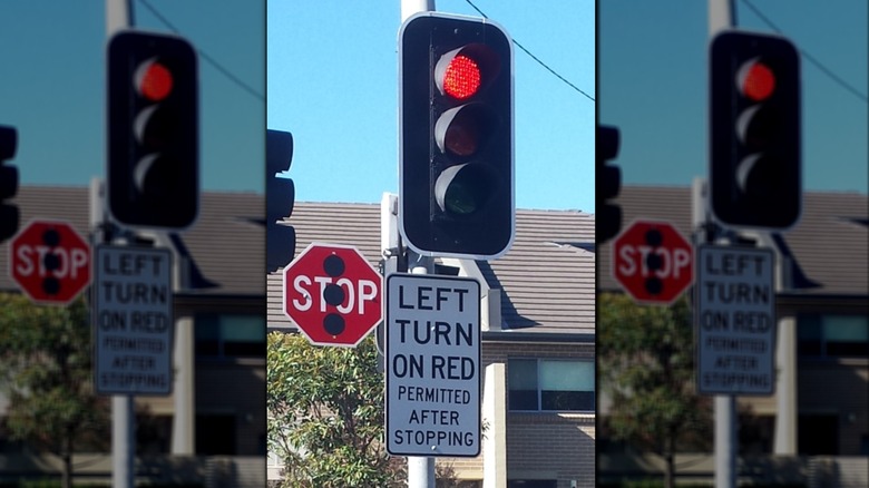 A traffic signal with left turn on red allowed sign
