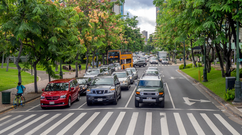 Cars crowd on Kalakaua Avenue successful Waikiki, Hawaii