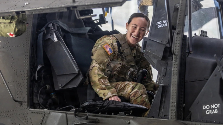 A 101st Combat Aviation Brigade pilot is adjusted in the cockpit of an AH-64 Apache helicopter before testing the Advanced Inflight Relief Universal System (AIRUS) at Fort Campbell, Kentucky, Oct. 5, 2026.