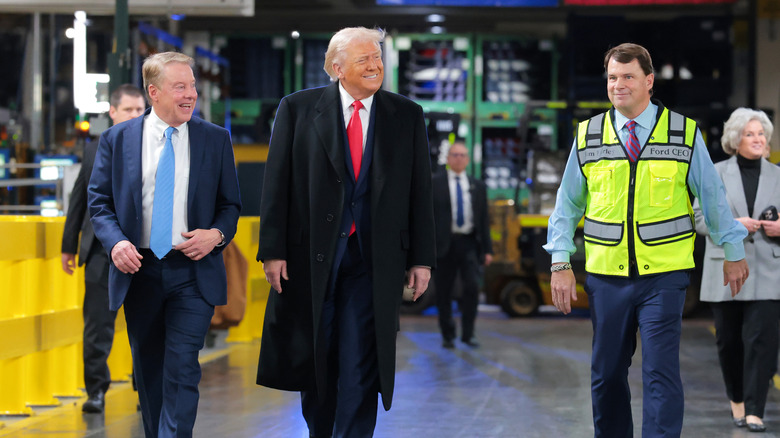 Bill Ford and Jim Farley walk with Trump at the F-150 factory