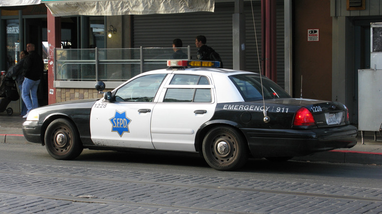 A Ford Crown Victoria interceptor cop car parked on a San Francisco street.