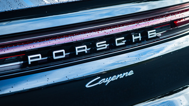 Apex, North Carolina - August 24 2025: Porsche Cayenne Luxury Performance SUV Front Rear Crest Emblem Logo Detail  by: PJ McDonnell