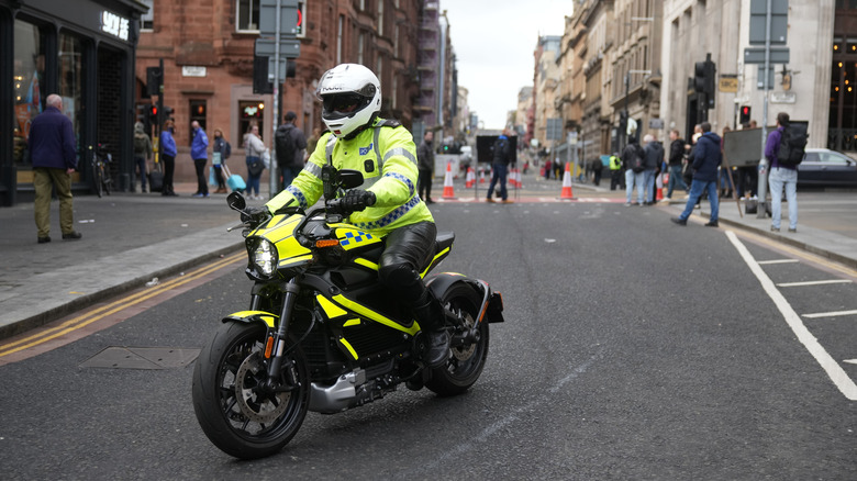 GLASGOW, SCOTLAND - NOVEMBER 05: A police officer on an electric motorcycle escorts the "Fridays For Future" climate rally during COP26 on November 5, 2021 in Glasgow, Scotland.