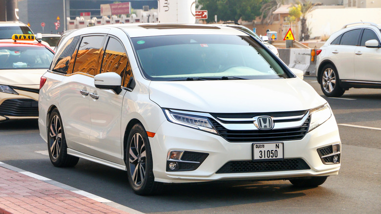 Dubai, UAE - July 3, 2024: White minivan Honda Odyssey in the city street.