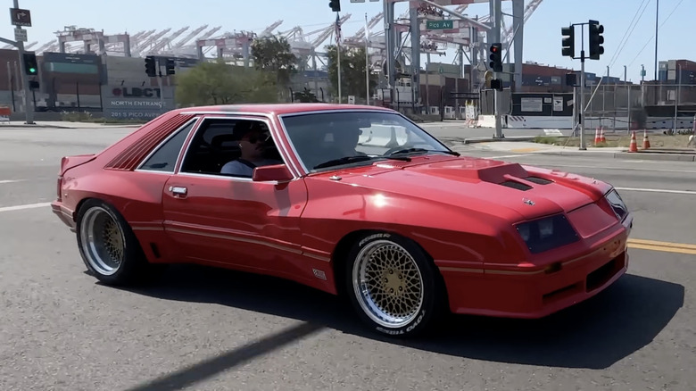 A rare red M81 Ford McLaren Mustang driven on the road.