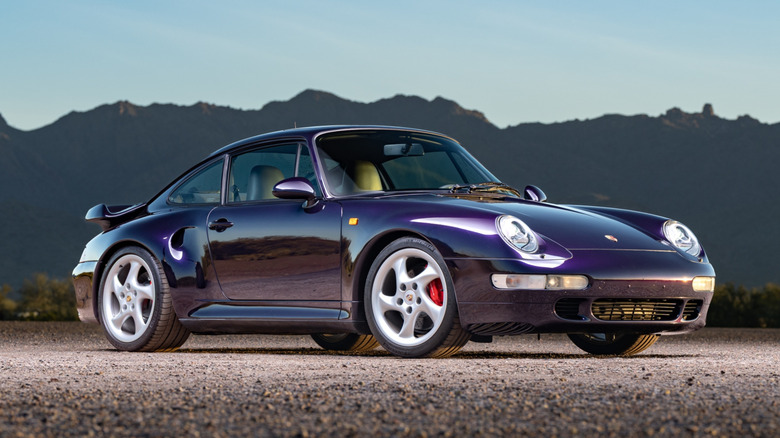 A 993-generation Porsche 911 Turbo parked on rocky terrain.