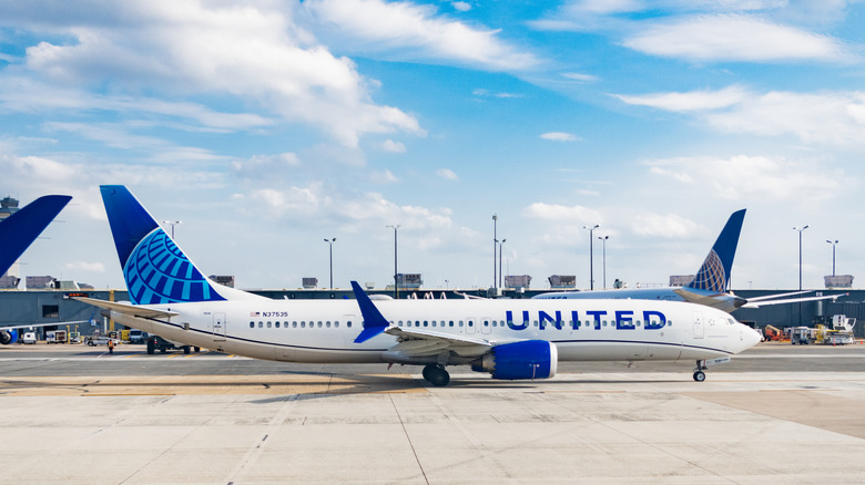 United airline plane departure in airport. Airport terminal. Plane arrival of United airline. Departure and arrival at airport. Airplane terminal area.