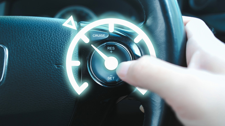 Automotive cruise control system on the steering wheel of the car with speedometer lock indicator and driver hand