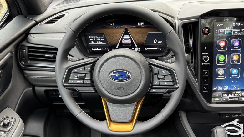 A close-up of the steering wheel of the Subaru Forester Wilderness showing the driver's assistance screen on the digital gauge readout
