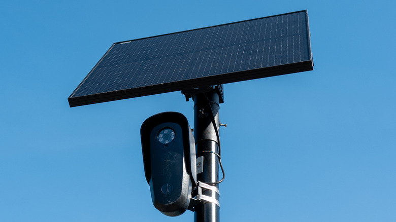 A Flock, solar-powered camera setup against a blue sky.
