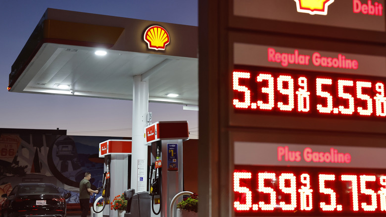 A customer stands near gas prices displayed at a gas station on July 7, 2026 in Pasadena, California.