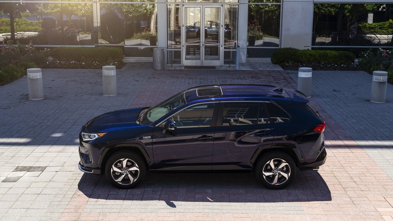 A 2021 Toyota RAV4 Prime plug-in hybrid parked by a building