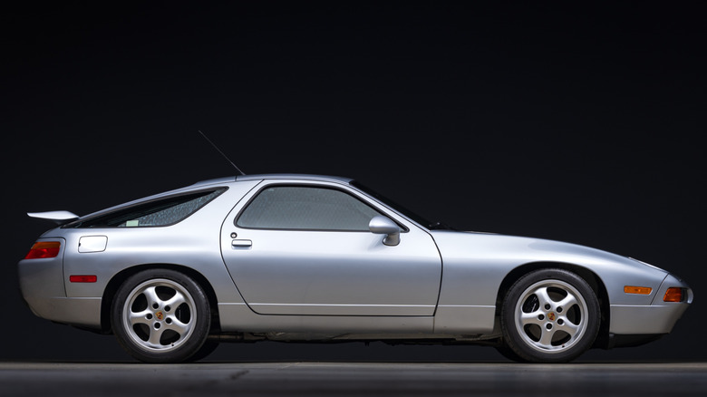Silver Porsche 928 side profile with black background