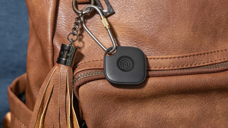 Closeup of Life360 Tile Mate in black attached to a bag.