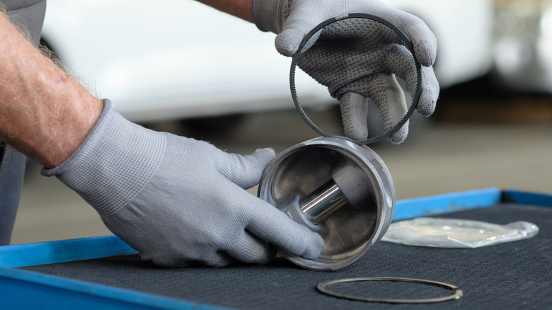 Mechanic handling piston and piston rings
