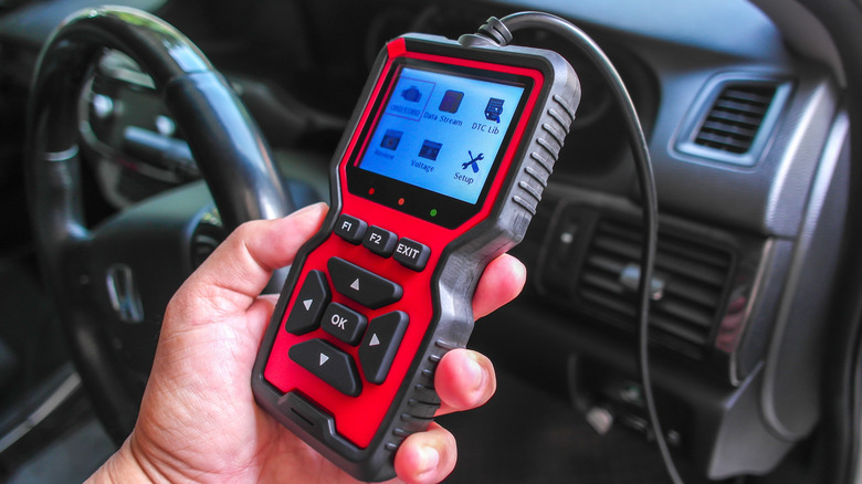 Mechanic using an OBD scanner