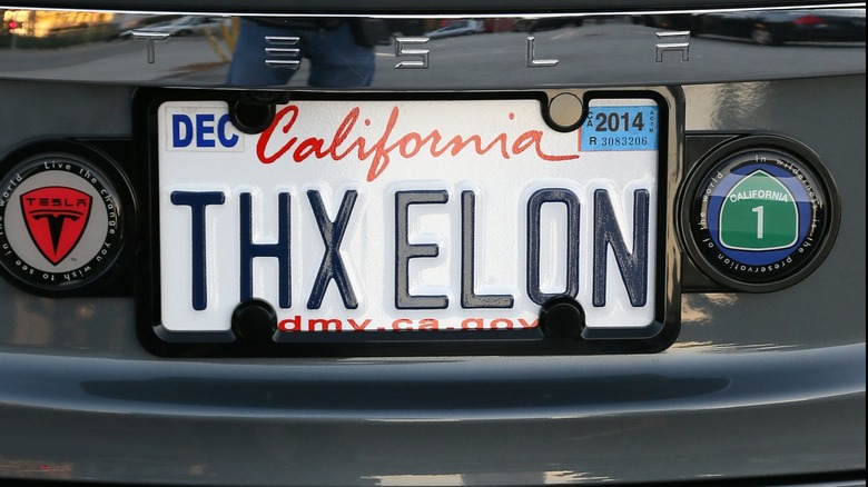 A California vanity license plate reads, "THX ELON." The plate is on the back of a Tesla.