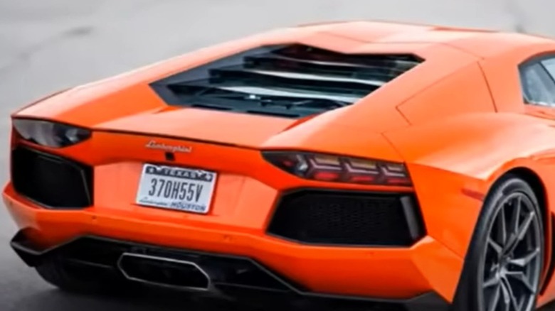 A Lamborghini with a vanity license plate that reads, "370H55V."